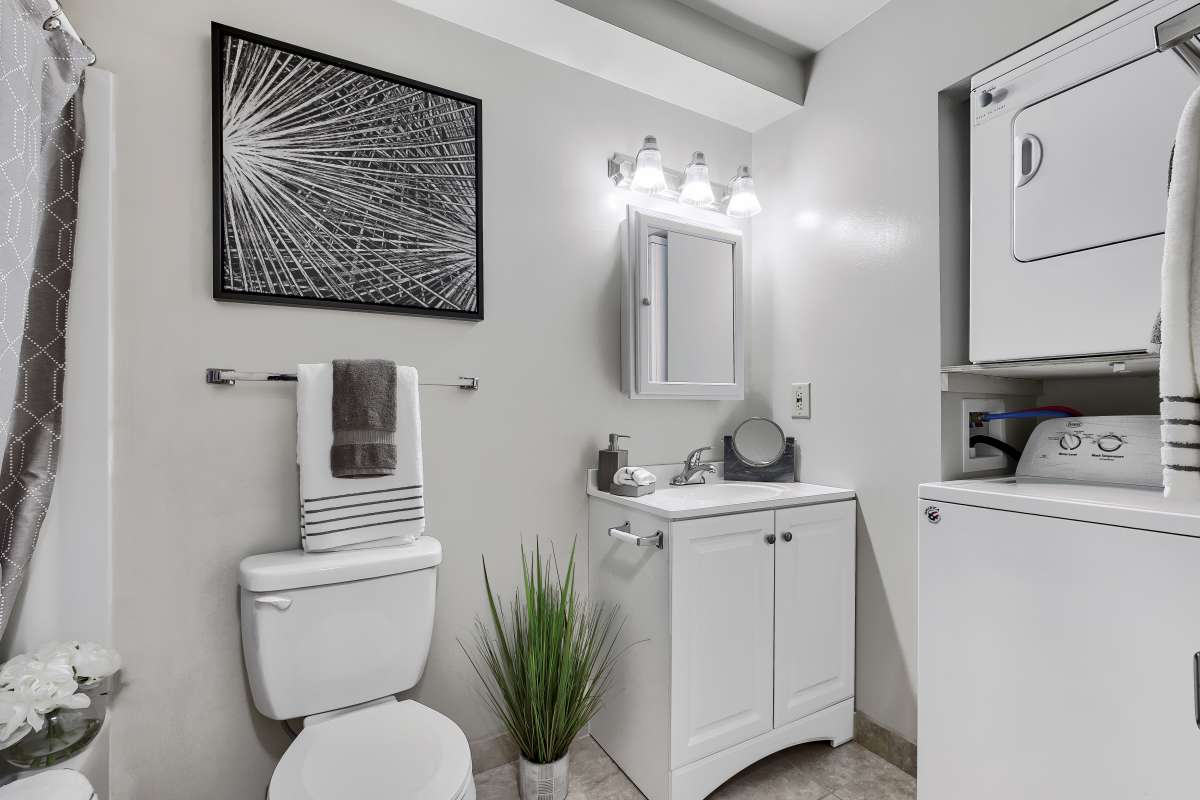 Resident bathroom with washer and dryer nook at Tall Trees in Scranton, Pennsylvania
