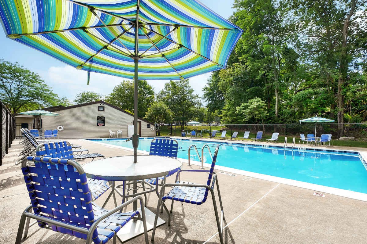 Swimming area with patio tables and chairs at Tall Trees in Scranton, Pennsylvania