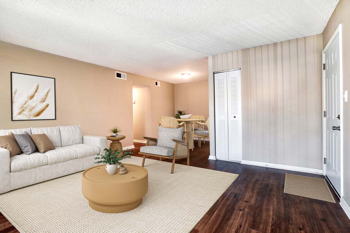 Model living space with wood-style flooring at Royal Palms in Orlando, Florida