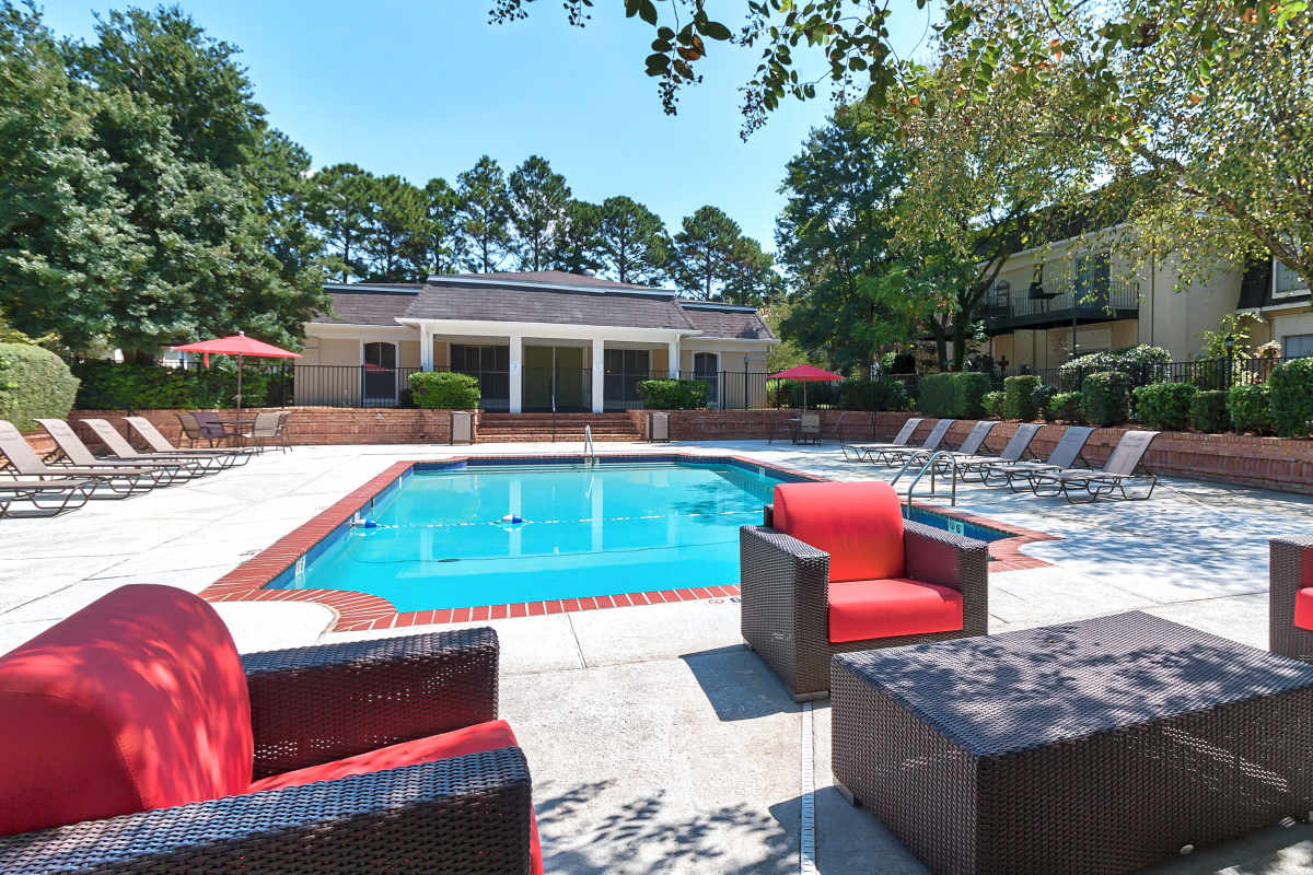 Community pool with seating and gathering spaces at Maison Imperial in Mobile, Alabama