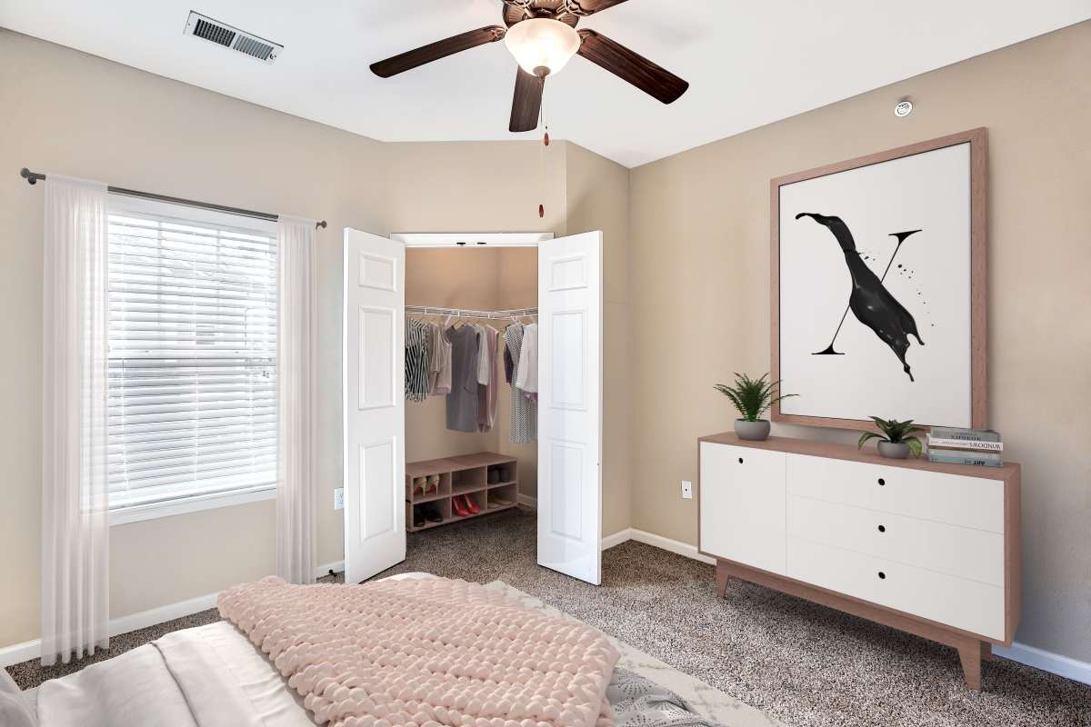 Resident bedroom with a ceiling fan at Renaissance at Peacher's Mill in Clarksville, Tennessee