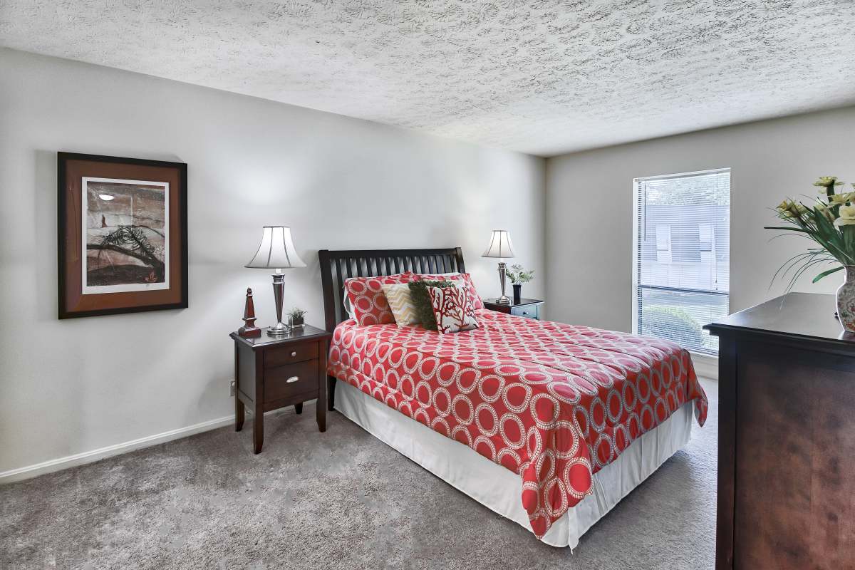 Resident bedroom with plush carpeting at La Fontenay in Louisville, Kentucky