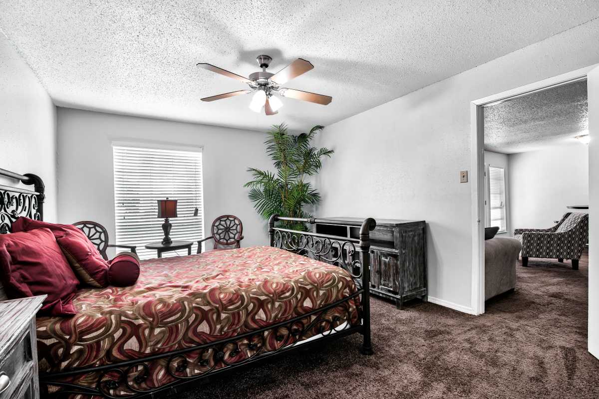 Resident bedroom with a ceiling fan at Sherwood Acres in Baton Rouge, Louisiana