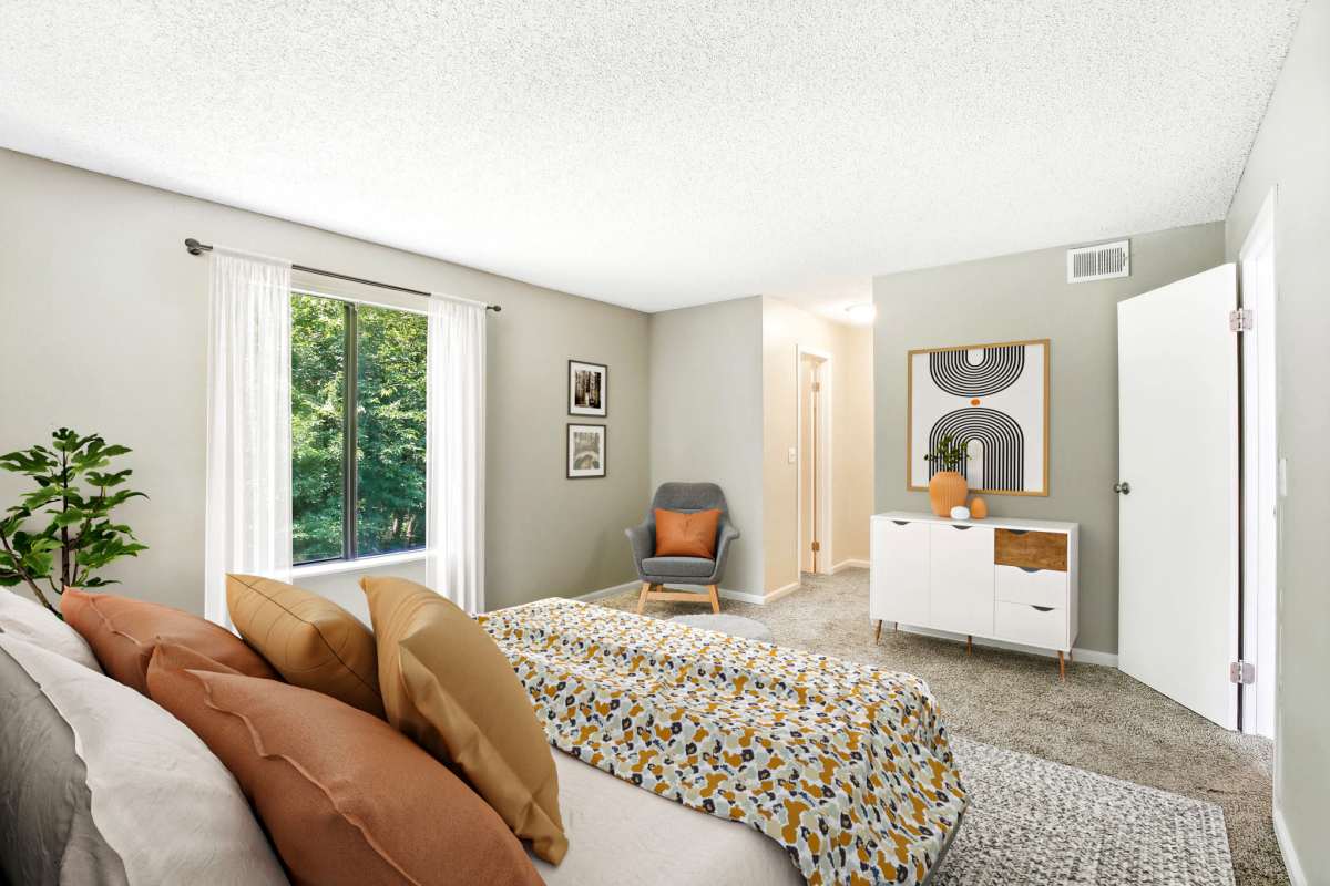 Resident bedroom with plush carpeting at Casa De Fuentes in Overland Park, Kansas