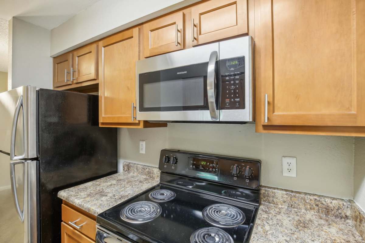 Modern kitchen with wood-style flooring at Casa De Fuentes in Overland Park, Kansas