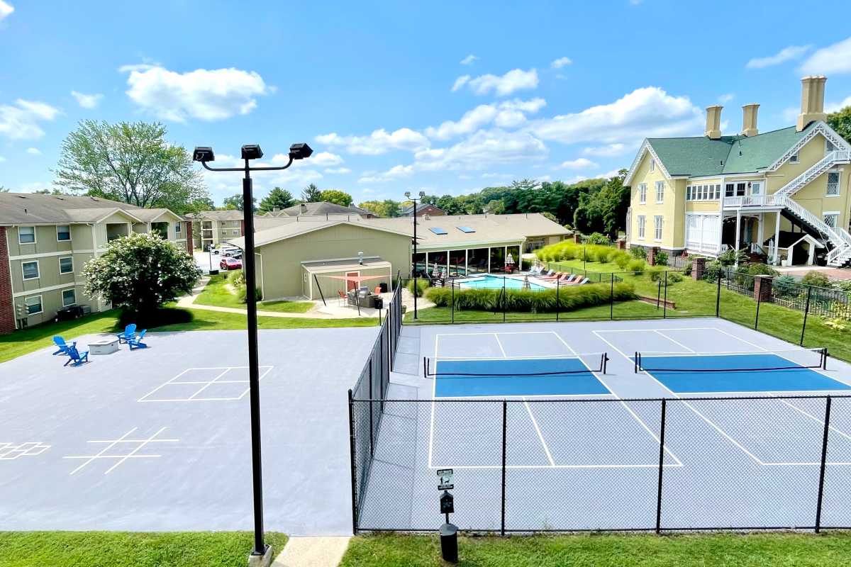 Pickleball courts, concrete play area, and outdoor seating at Cypress Pointe in Louisville, Kentucky