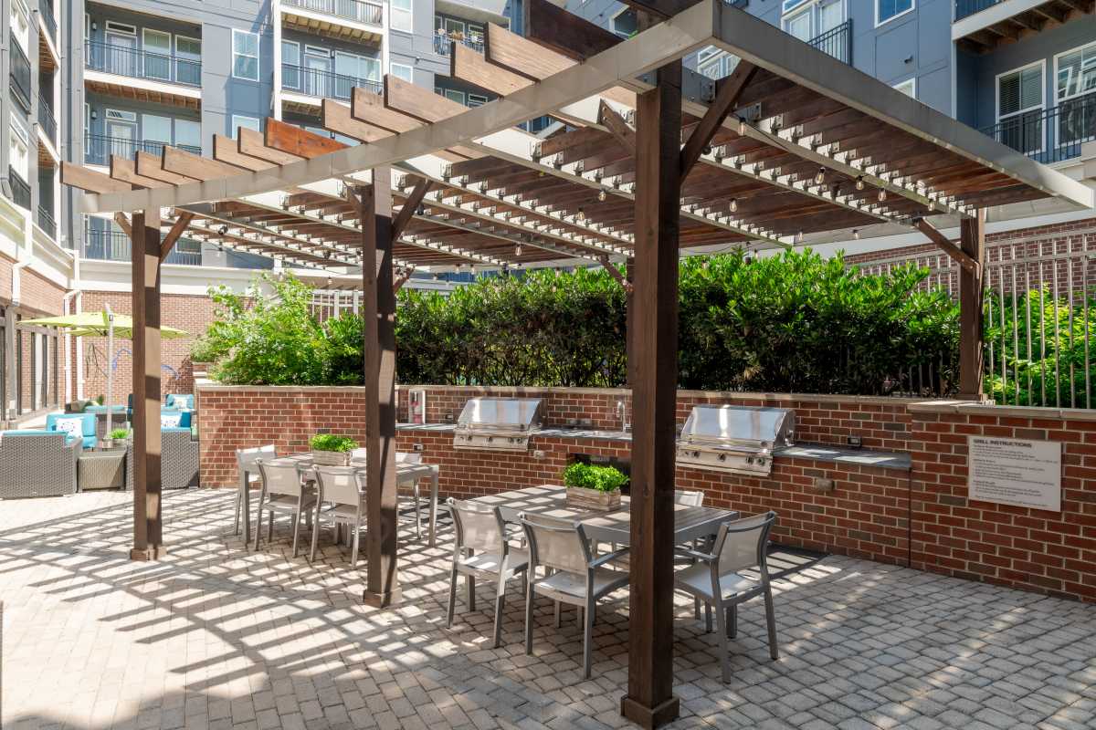 A patio with a pergola and chairs at The Tala at Washington Hill in Baltimore, Maryland