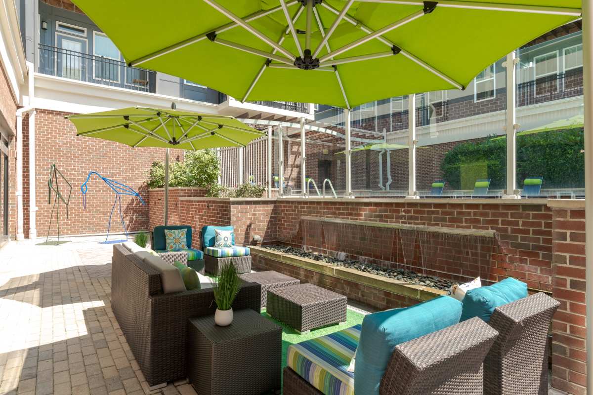 A patio with chairs and umbrellas at The Tala at Washington Hill in Baltimore, Maryland