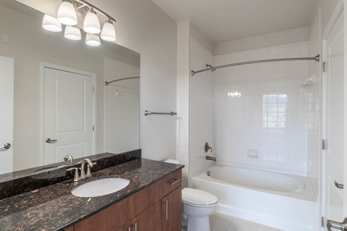 Bathroom with a large vanity mirror at The Tala at Washington Hill in Baltimore, Maryland