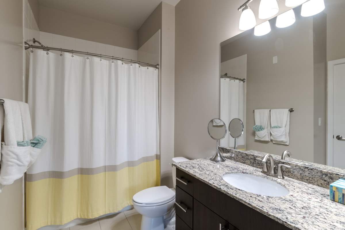 A bathroom with a shower curtain at The Tala at Washington Hill in Baltimore, Maryland