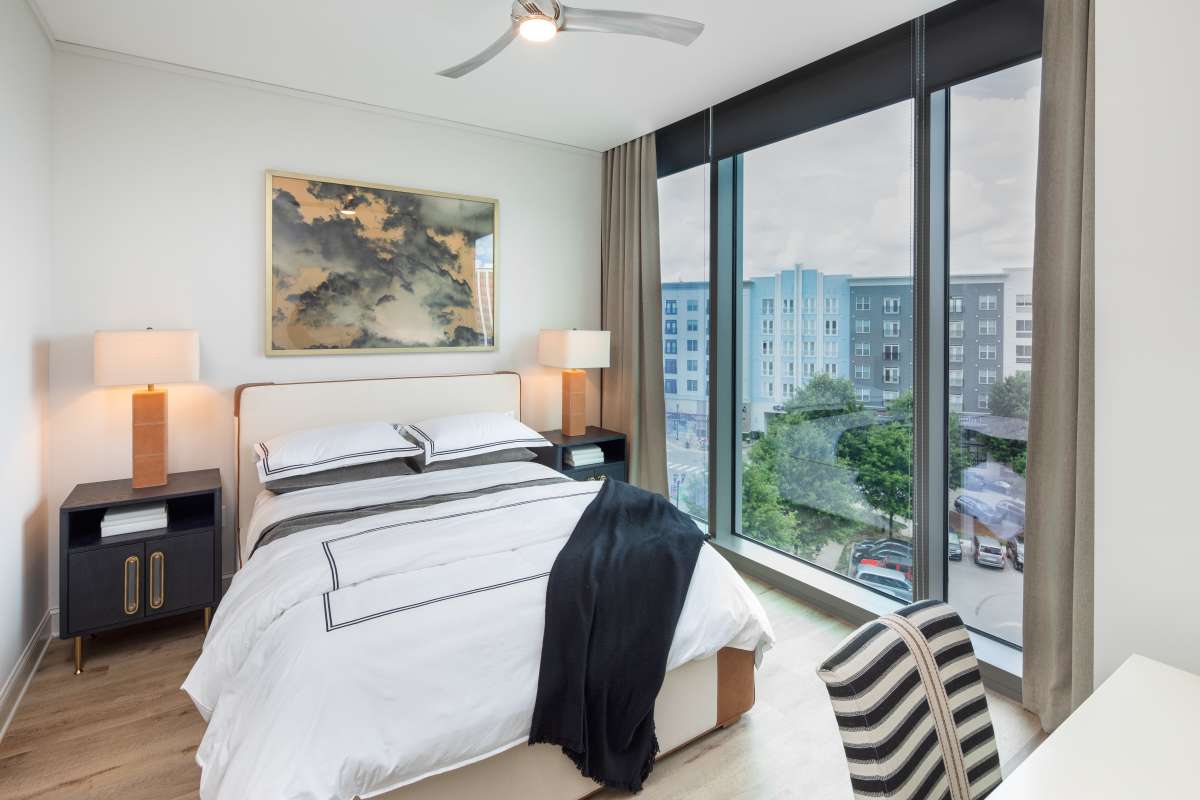 Bedroom with a bright window at The Eastern in Raleigh, North Carolina