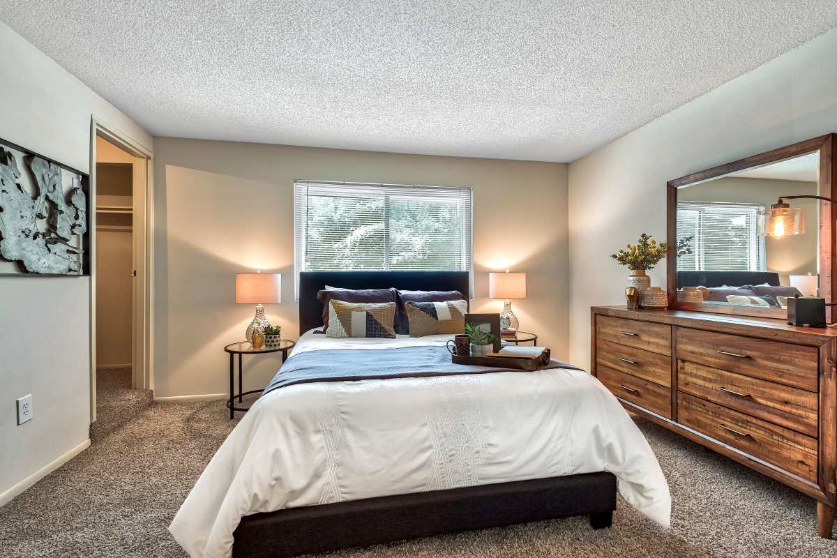 Resident master bedroom with plush carpeting at The Pines in Harrisburg, Pennsylvania