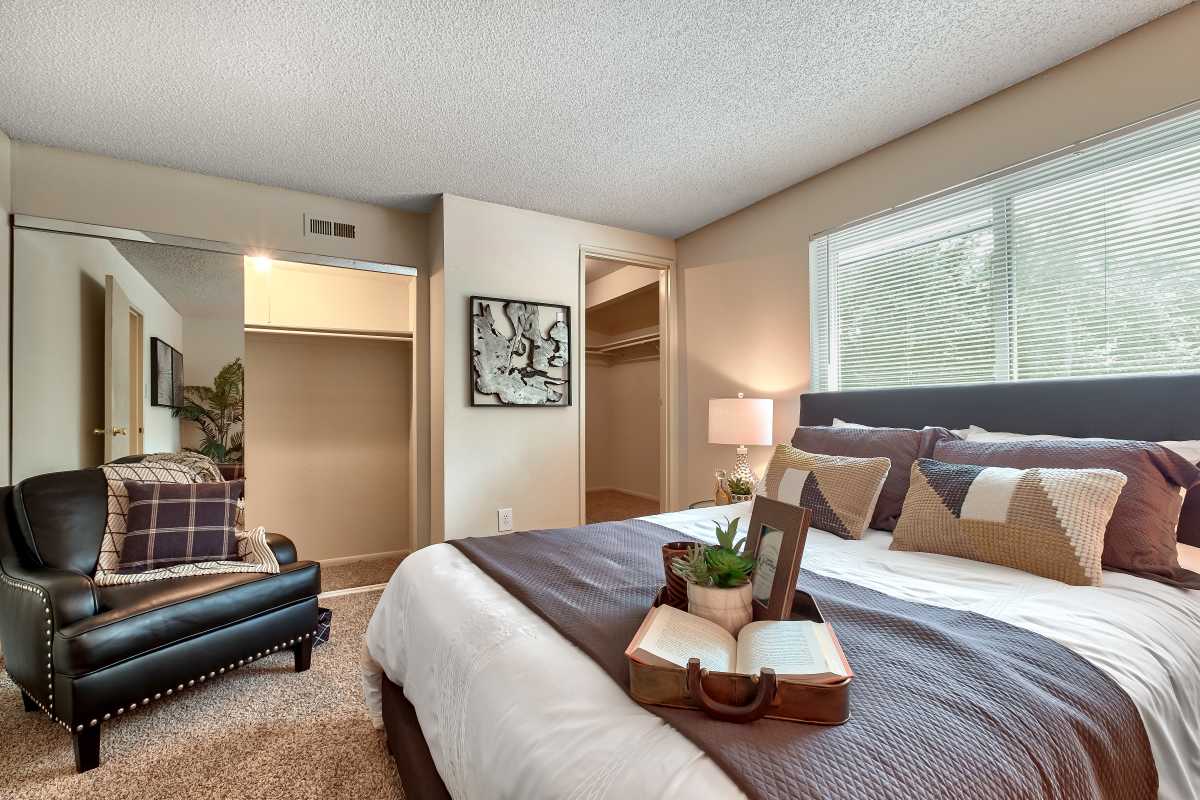 Resident master bedroom with plush carpeting at The Pines in Harrisburg, Pennsylvania