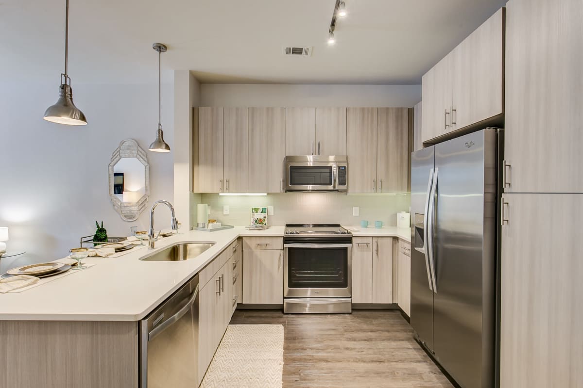 Stainless-steel appliances inside the apartment kitchen at Factory Design District in Dallas, Texas