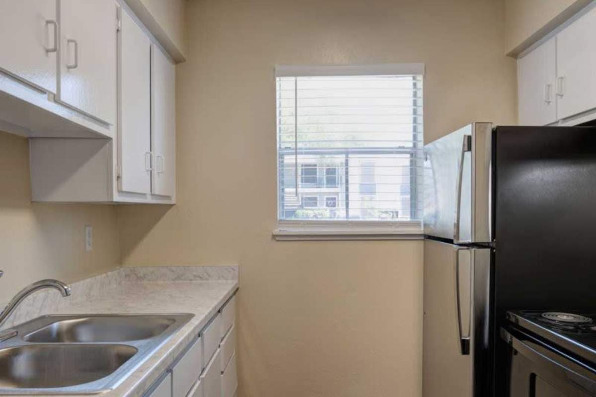 Kitchen with stainless-steel appliances at Meyerland Court in Houston, Texas