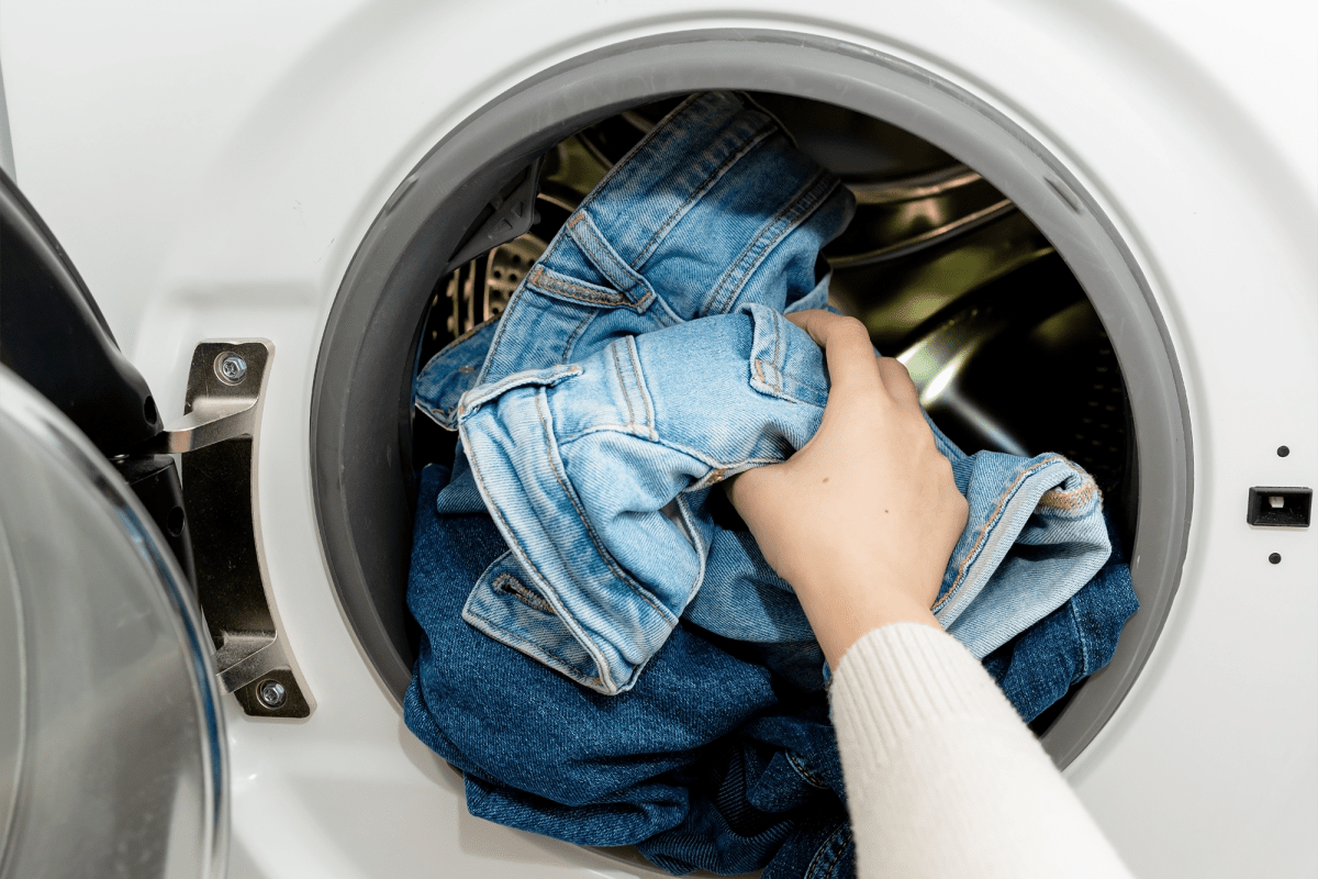 Woman putting laundry in the washer at LoHi Gold in Denver, Colorado