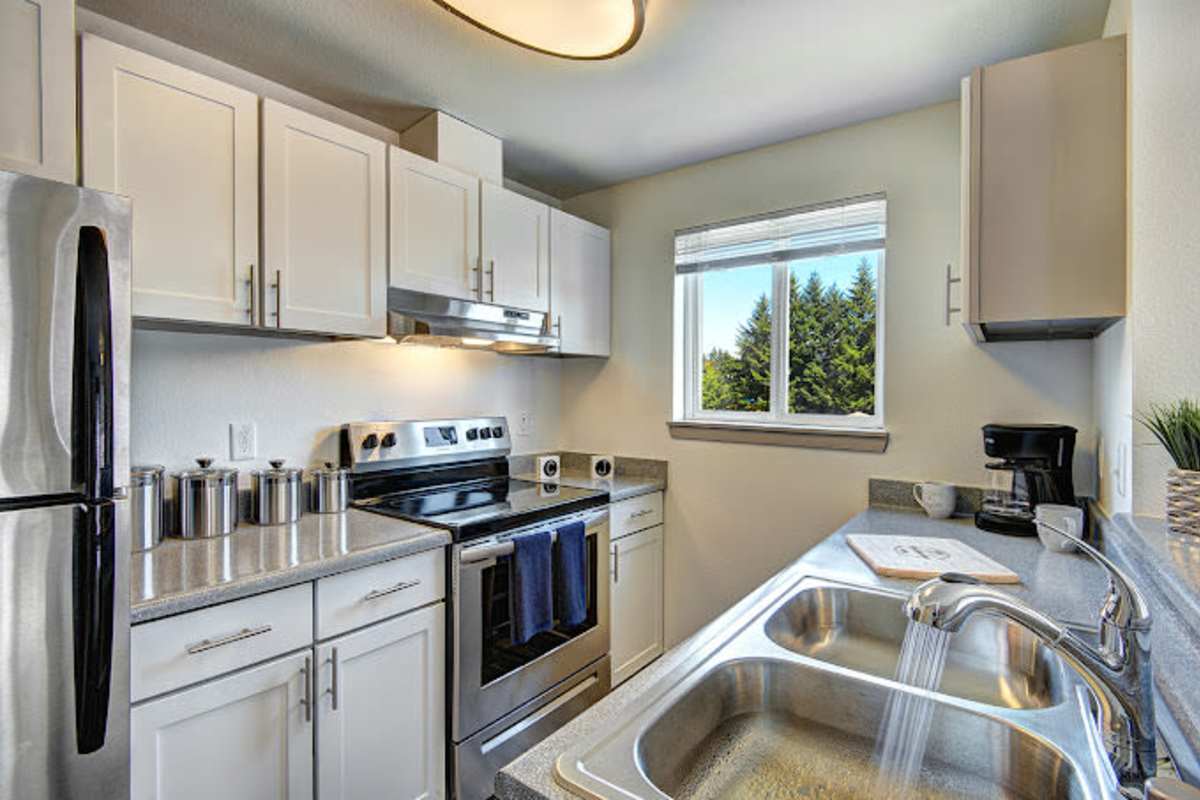 Fully-equipped kitchen with stainless steel appliances at Briarstone in Tacoma, Washington