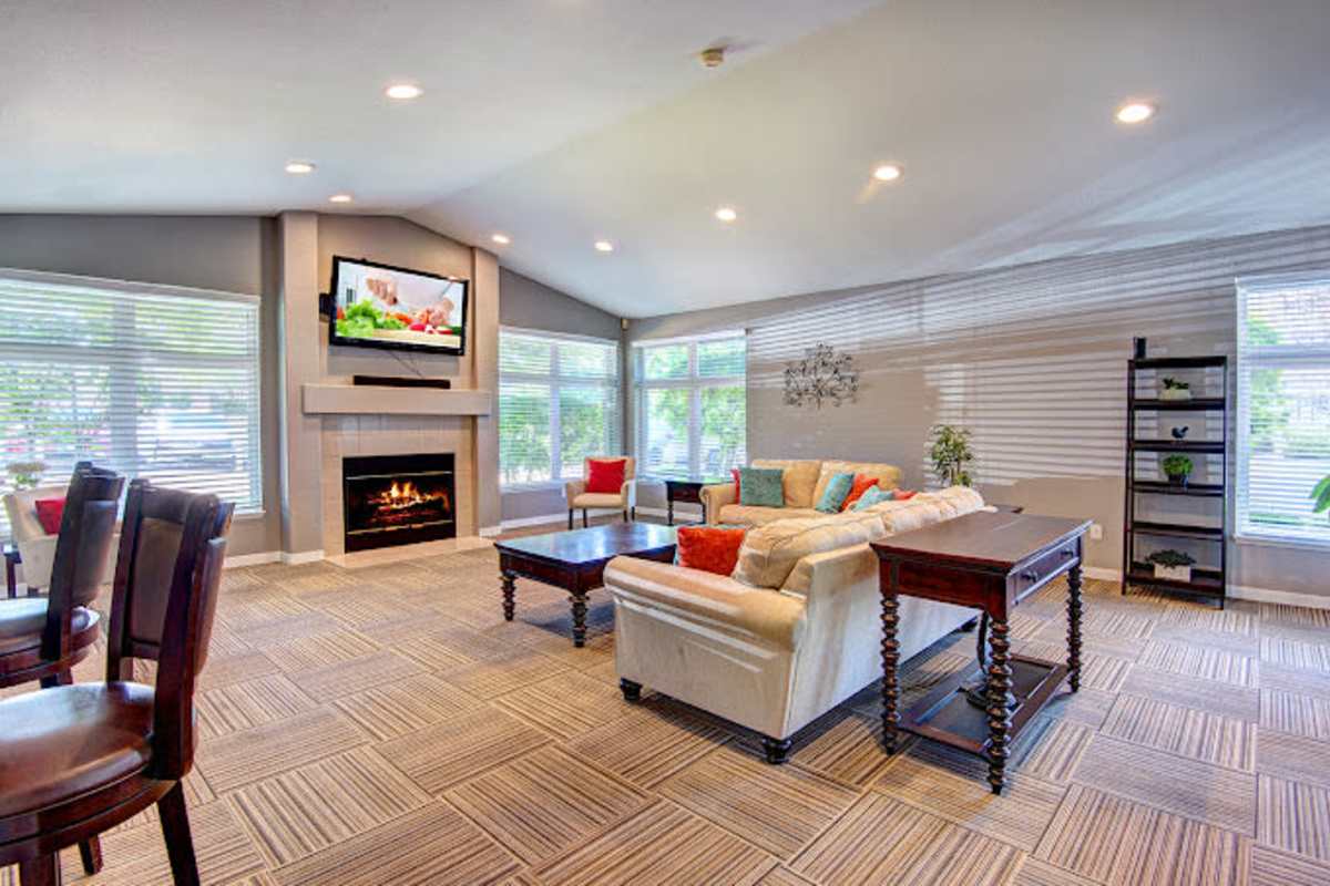 Community clubhouse with couch, fireplace and lots of seating at Briarstone in Tacoma, Washington