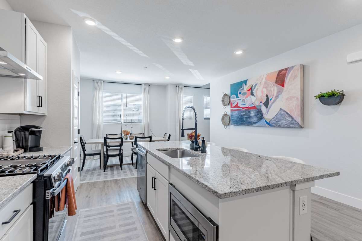 Kitchen featuring granite island & dining area 
