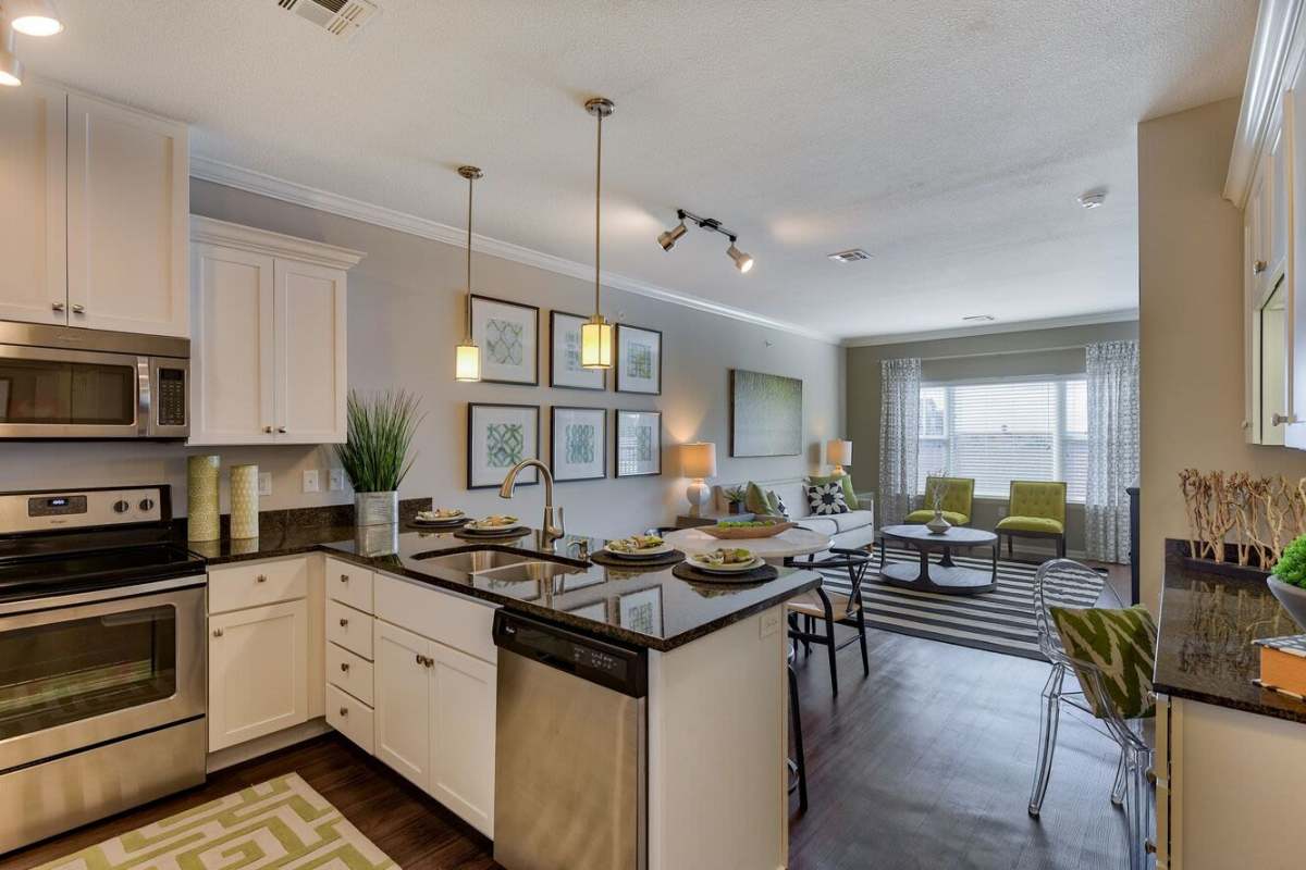 Man putting laundry in the washer at The Residences at New Longview in Lee's Summit, Missouri
