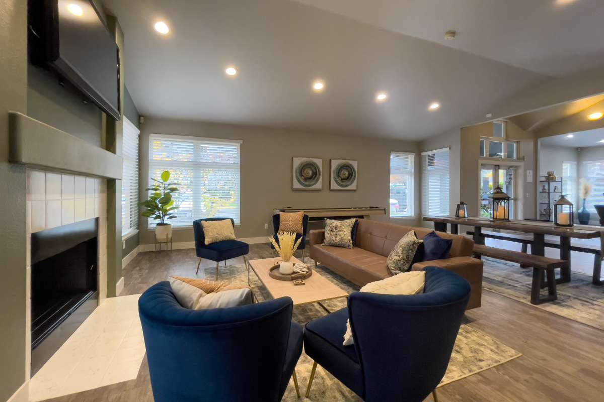 Modern design clubhouse with large lounge chairs and televisions at Briarstone in Tacoma, Washington
