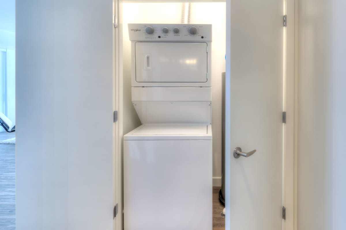 Woman putting laundry in the washer at Ellison in Des Plaines, Illinois