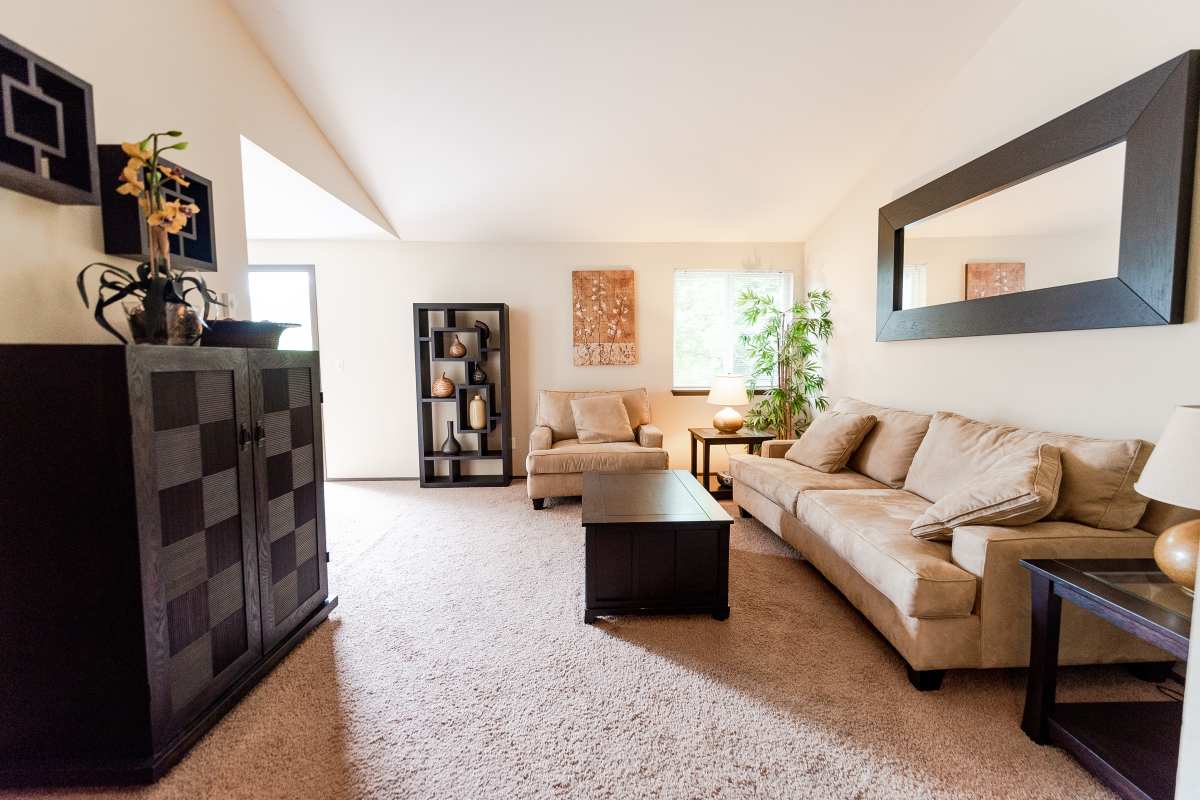 Spacious living room with couch, coffee table at Briarstone in Tacoma, Washington