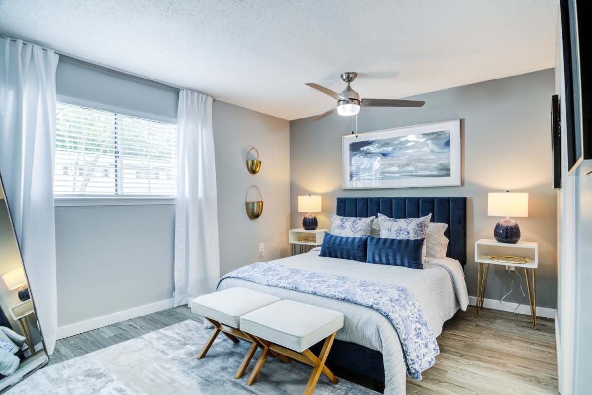 Bedroom with large window and ceiling fan at Kenridge Apartments in Decatur, Georgia
