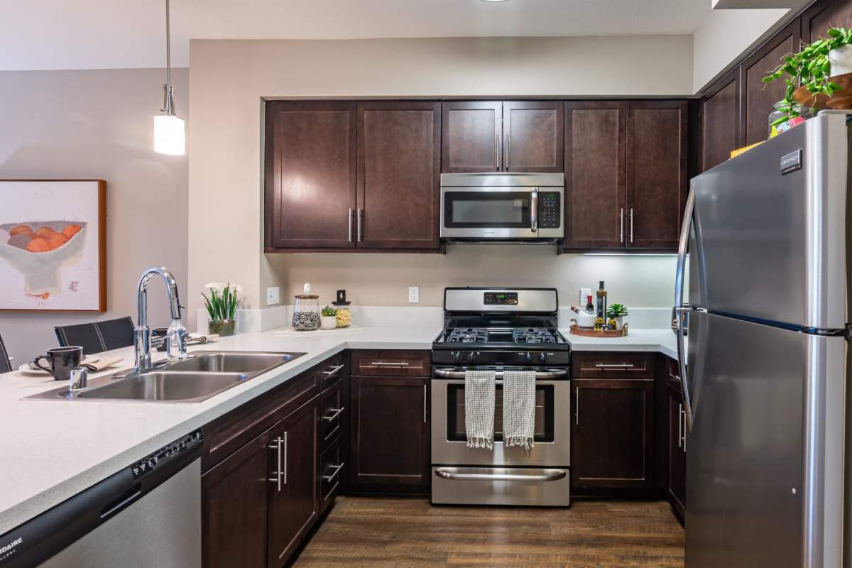 Kitchen with dark walnut color cabinet at The Boulevard Apartment Homes in Woodland Hills, California