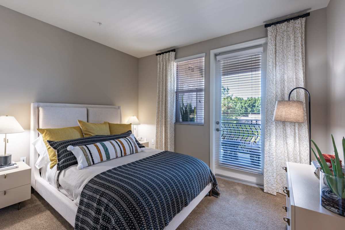 Bedroom with attached patio at The Boulevard Apartment Homes in Woodland Hills, California
