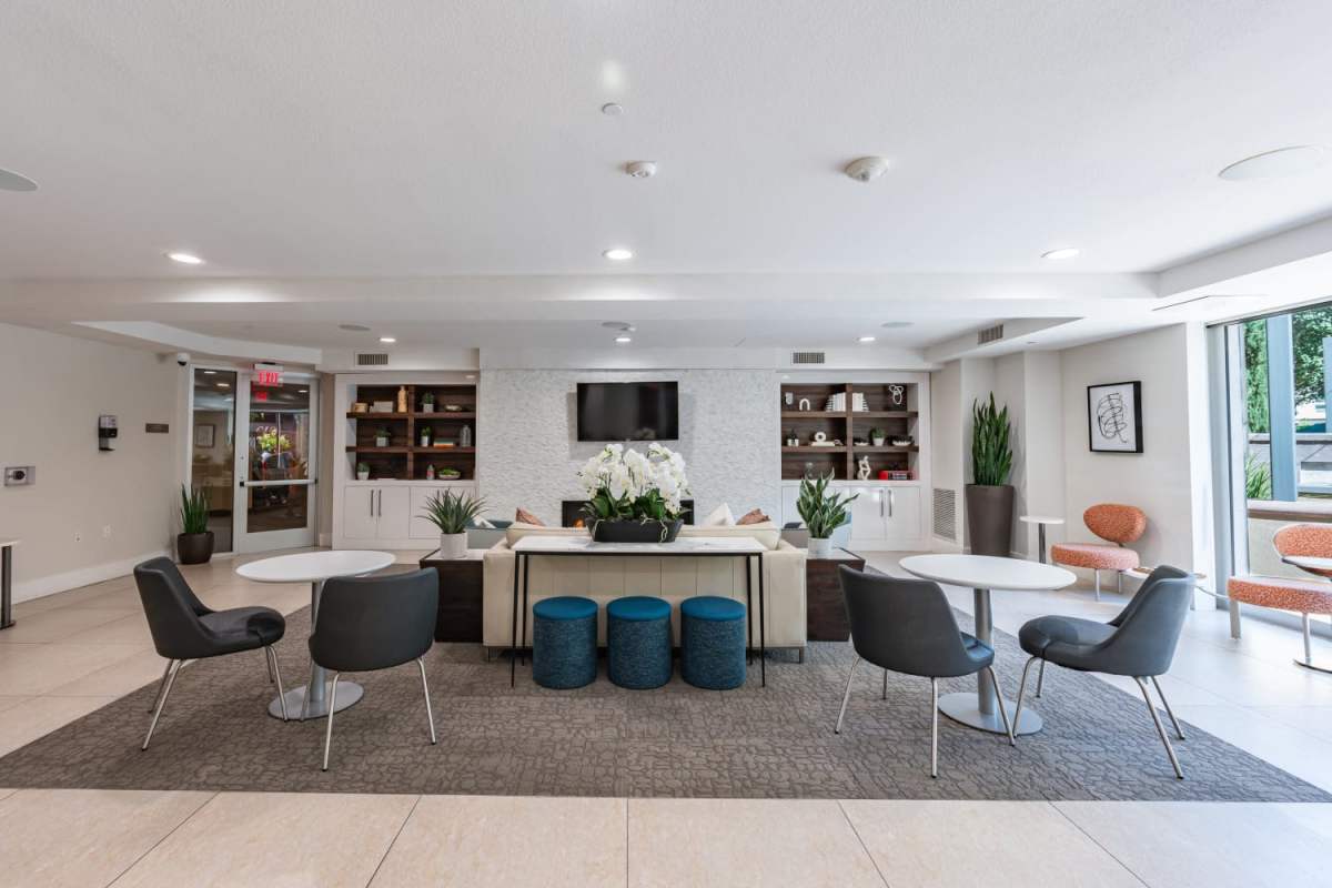 Clubhouse large seating area with television at The Boulevard Apartment Homes in Woodland Hills, California