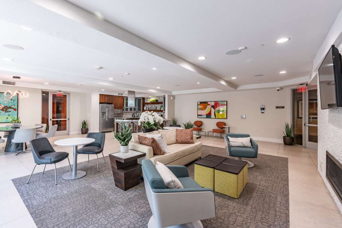 Clubhouse with seating area with view to kitchen at The Boulevard Apartment Homes in Woodland Hills, California
