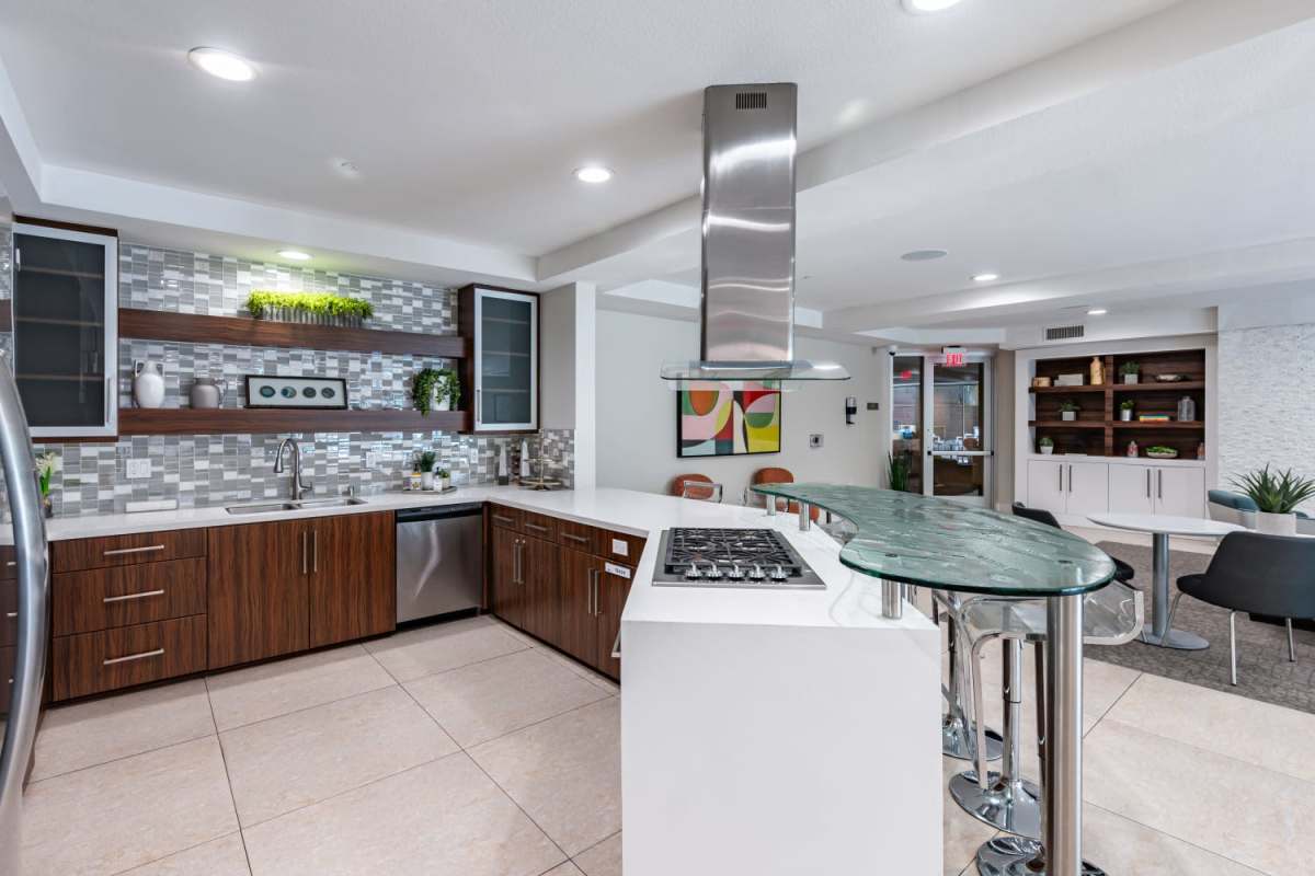 Community kitchen with white color countertop at The Boulevard Apartment Homes in Woodland Hills, California
