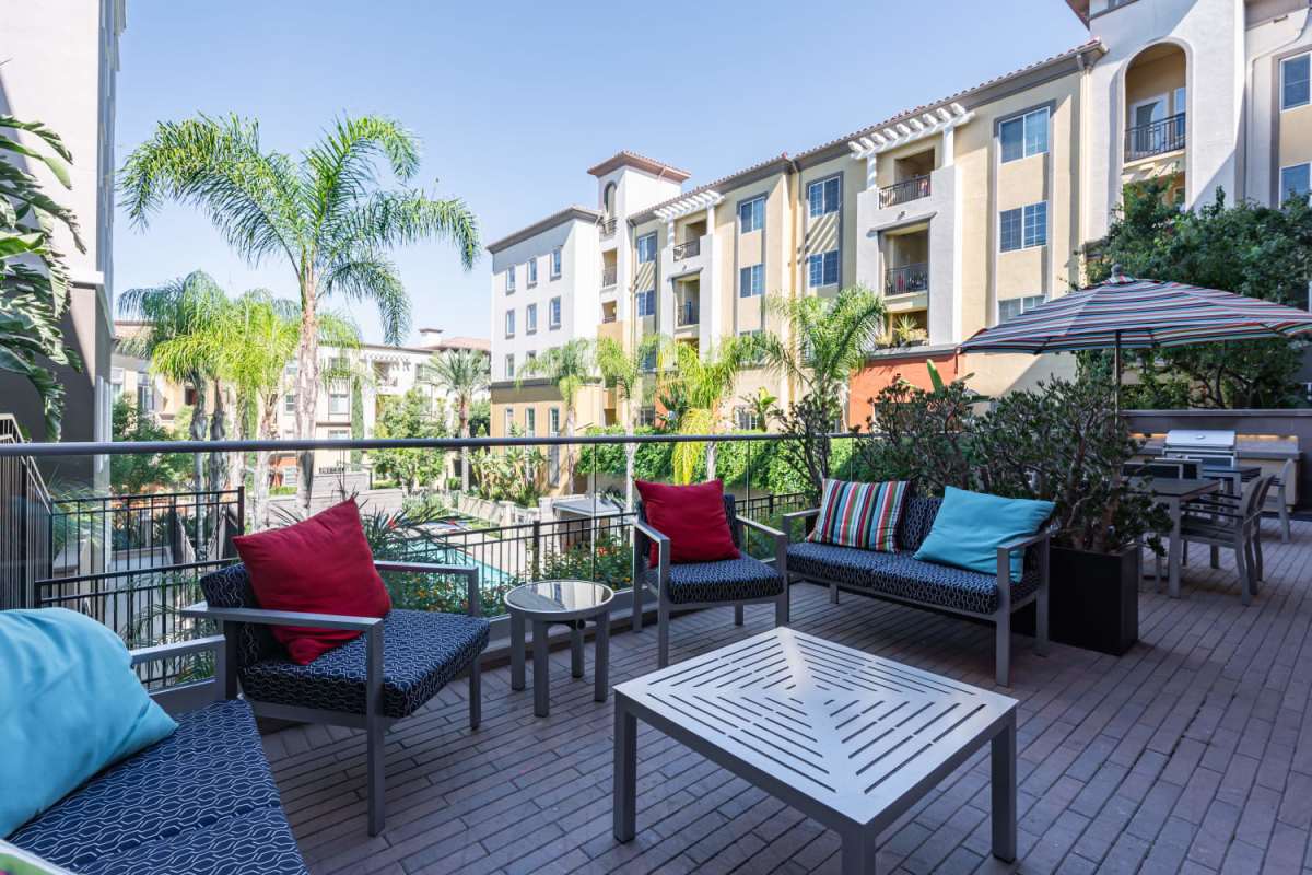 Outside seating area with grilling station at The Boulevard Apartment Homes in Woodland Hills, California 