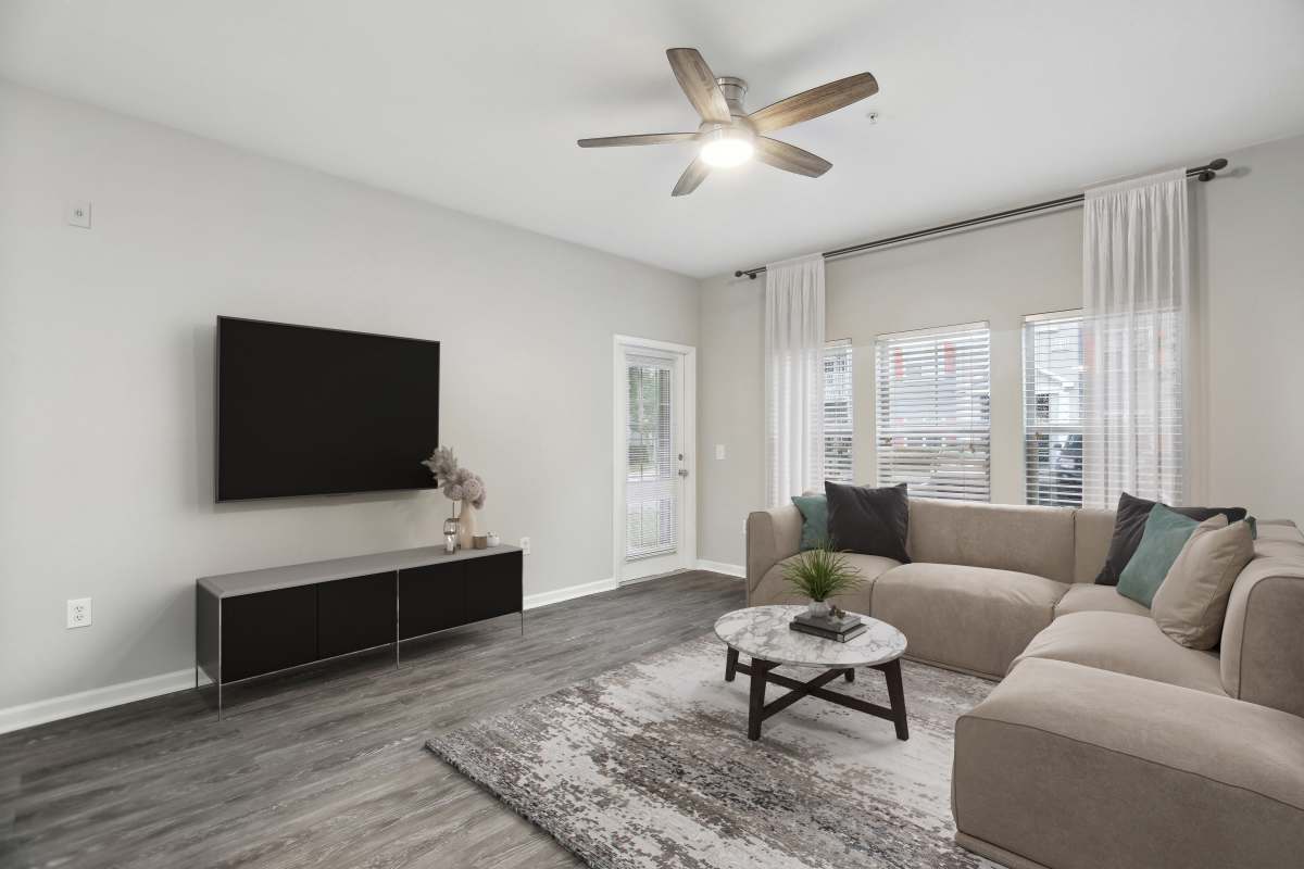 Spacious living room with a comfortable couch and large windows at The Haven At West Melbourne in West Melbourne, Florida