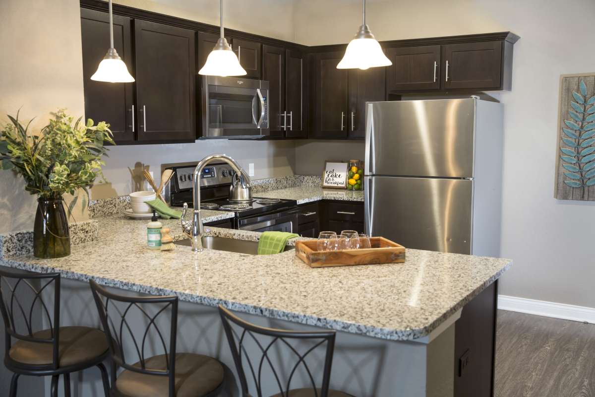 Spacious island kitchen with pendant lights at Brookside Downtown in Columbia, Missouri, 