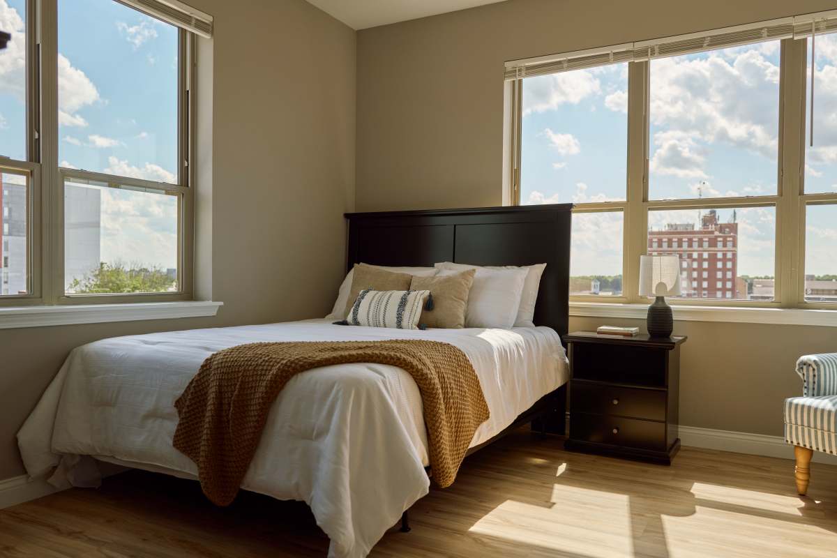 Bright bedroom with large windows at Brookside Downtown in Columbia, Missouri, 