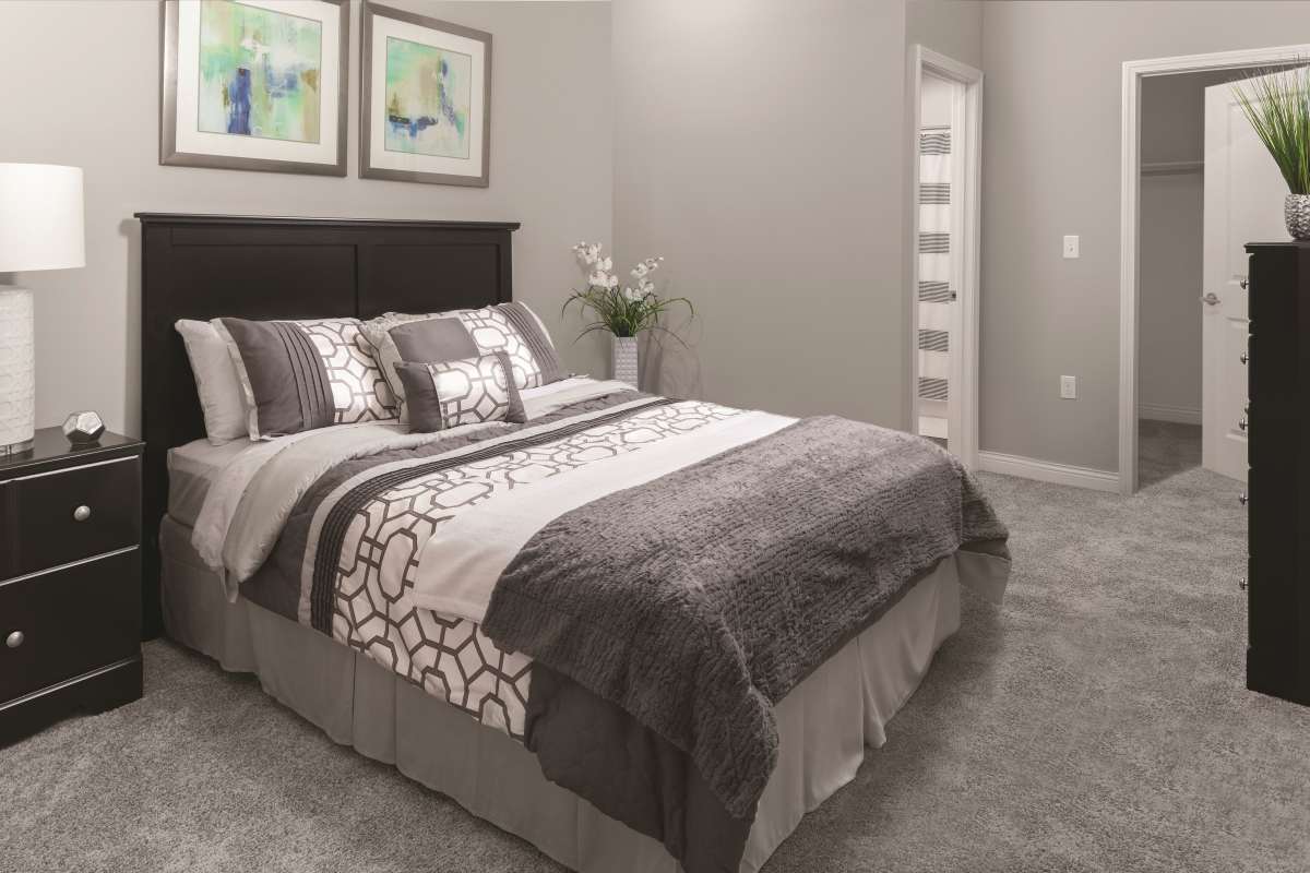 Spacious bedroom with large comfortable bed at Brookside Downtown in Columbia, Missouri, 