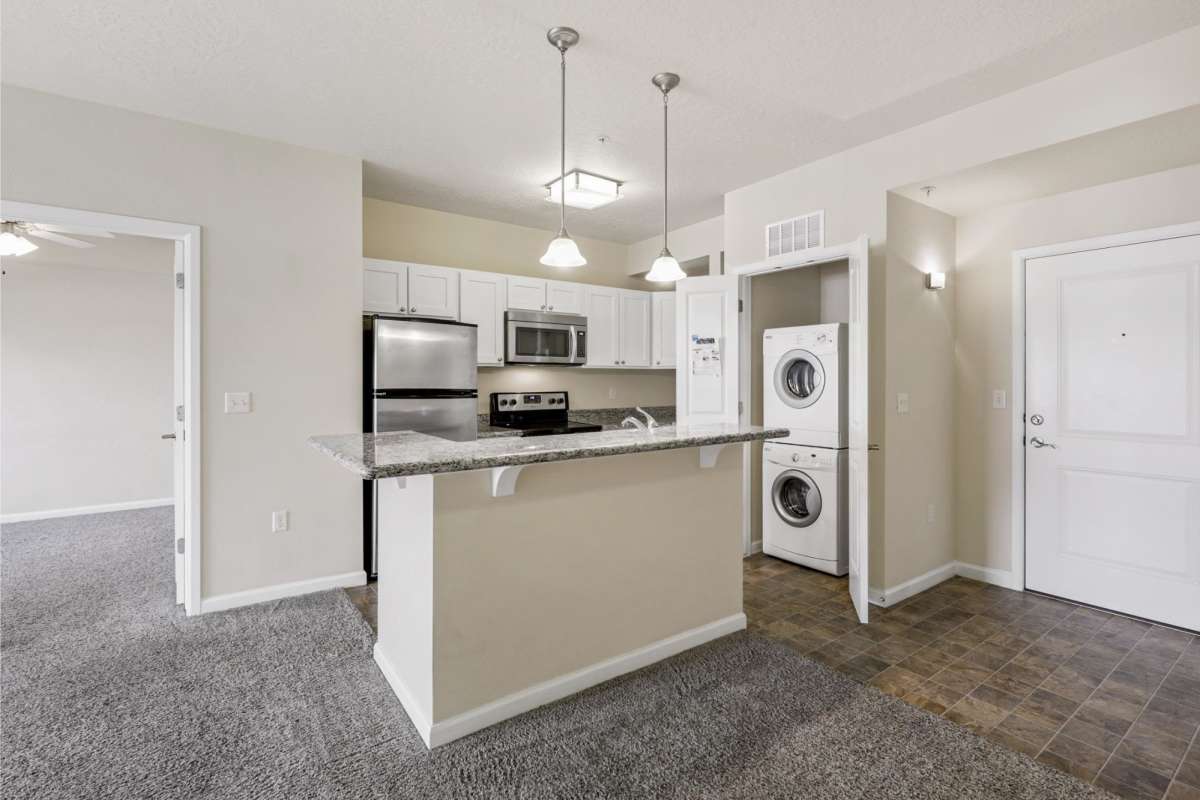 Stacked washer and dryer attached in kitchen at Sugar Flats in Salt Lake City, Utah