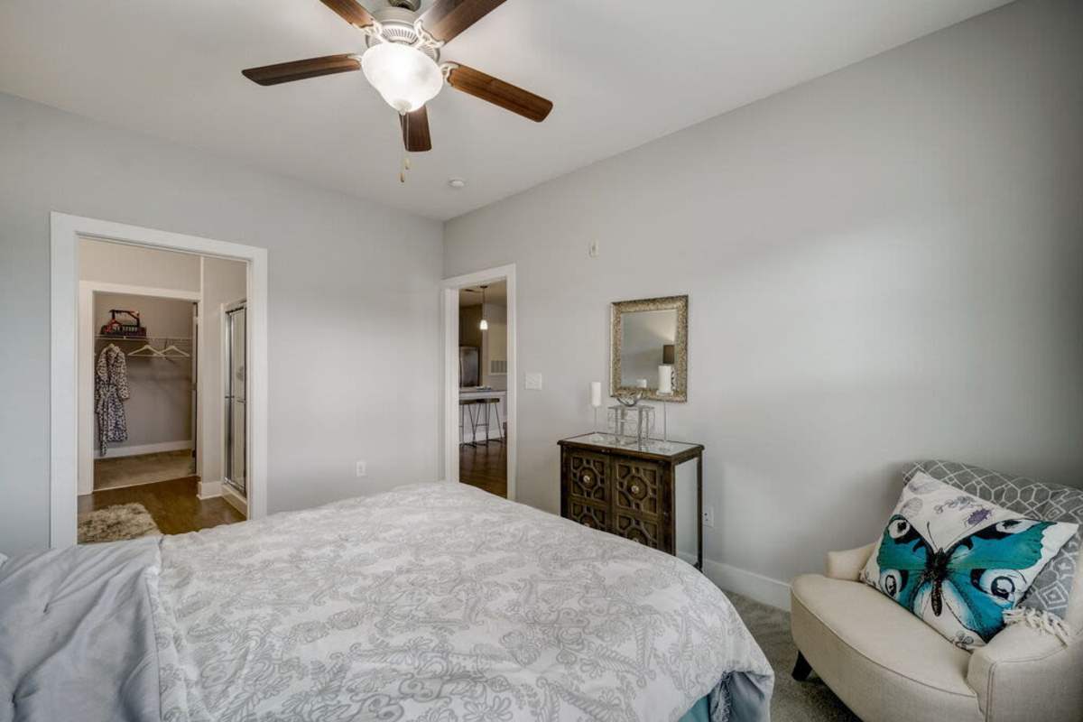 A beroom showcasing the doors going to the closet, living room and kitchen area at Century Park Place in Morrisville, North Carolina