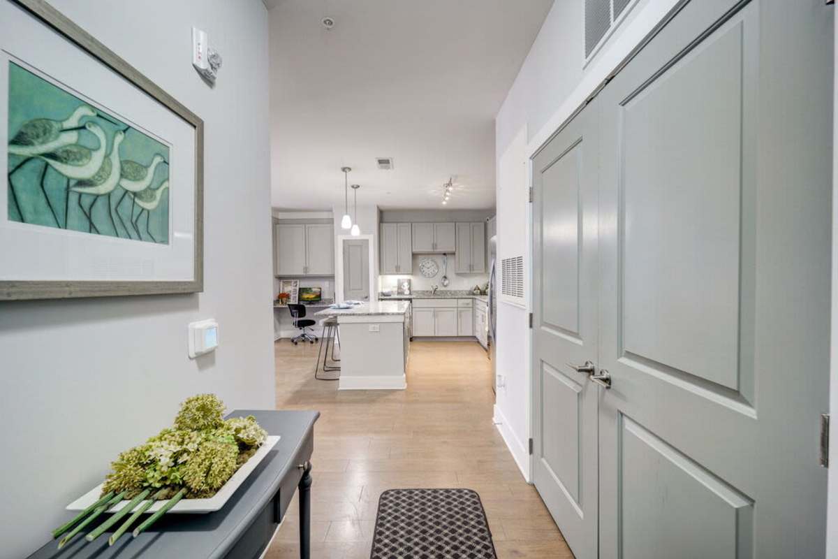 A space of the room that showcases the kitchen area and the small space for working and studying at Century Park Place in Morrisville, North Carolina