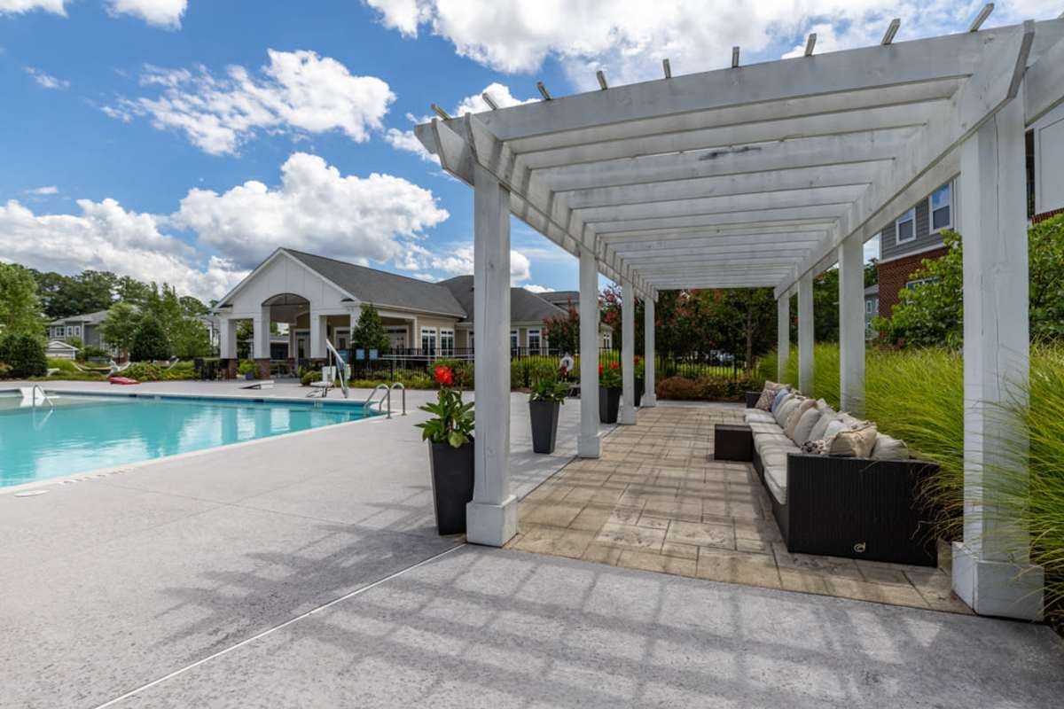 The pool area featuring lounge chairs and a serene atmosphere at Century Park Place in Morrisville, North Carolina
