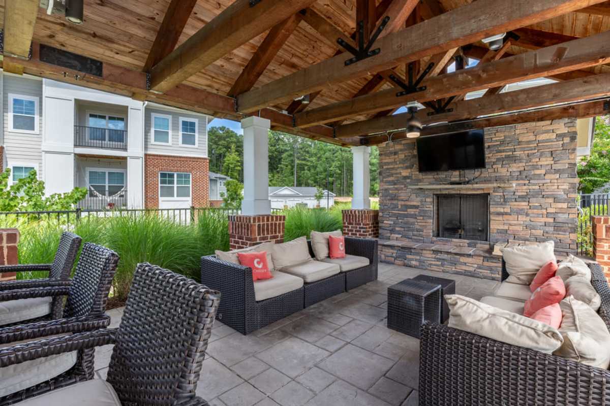 Outdoor patio area featuring seating and greenery at Century Park Place in Morrisville, North Carolina