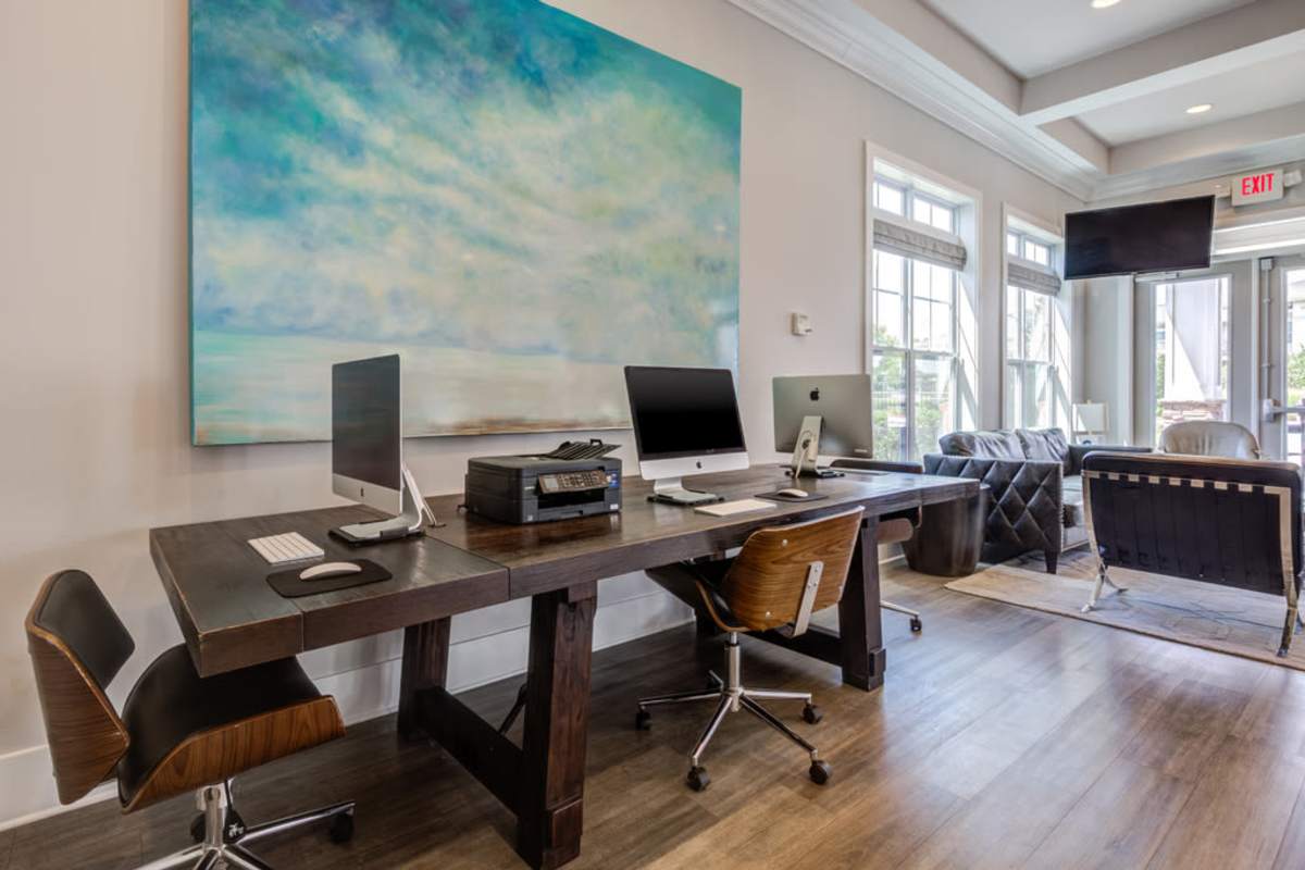 A home office featuring a large painting prominently displayed on the wall, enhancing the workspace's aesthetic appeal at Century Park Place in Morrisville, North Carolina
