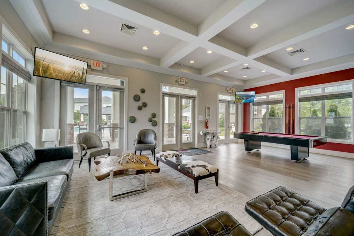 Living room at the Reserve at Westchester, featuring modern furnishings and large windows with natural light at Century Park Place in Morrisville, North Carolina