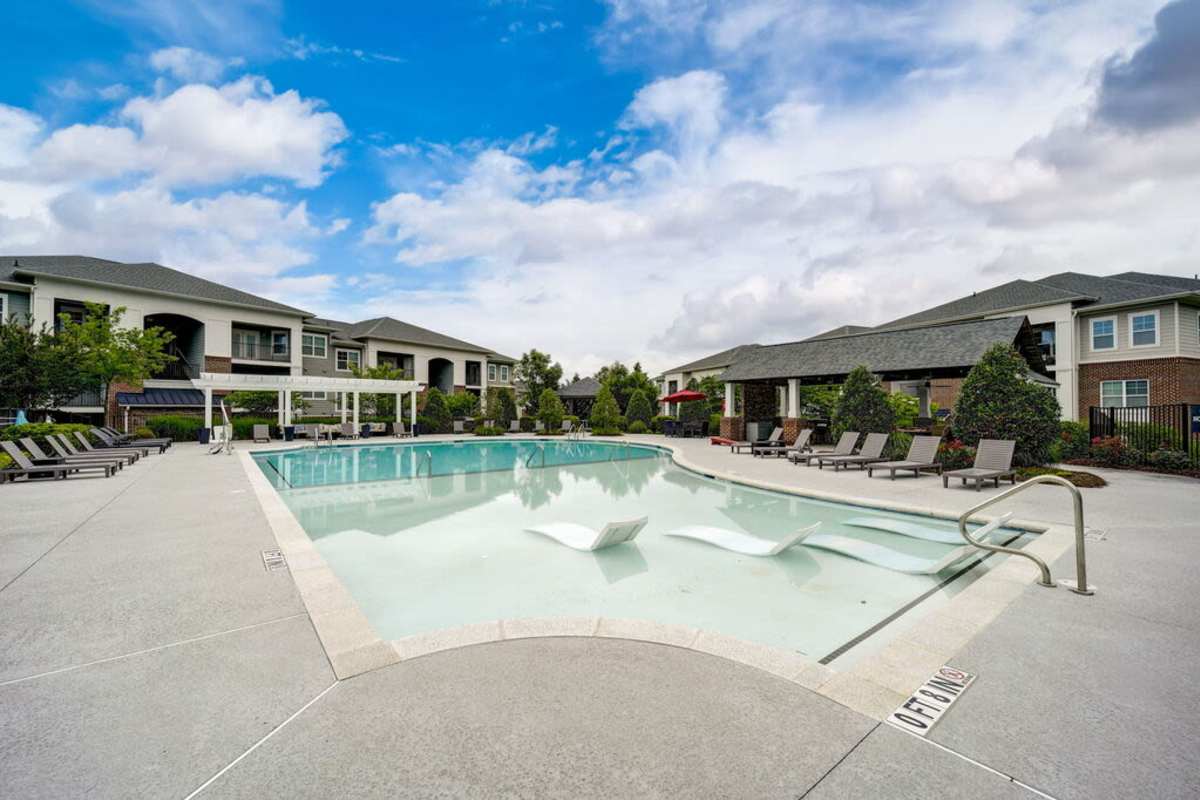 Outdoor swimming pool with beach chairs at Century Park Place in Morrisville, North Carolina