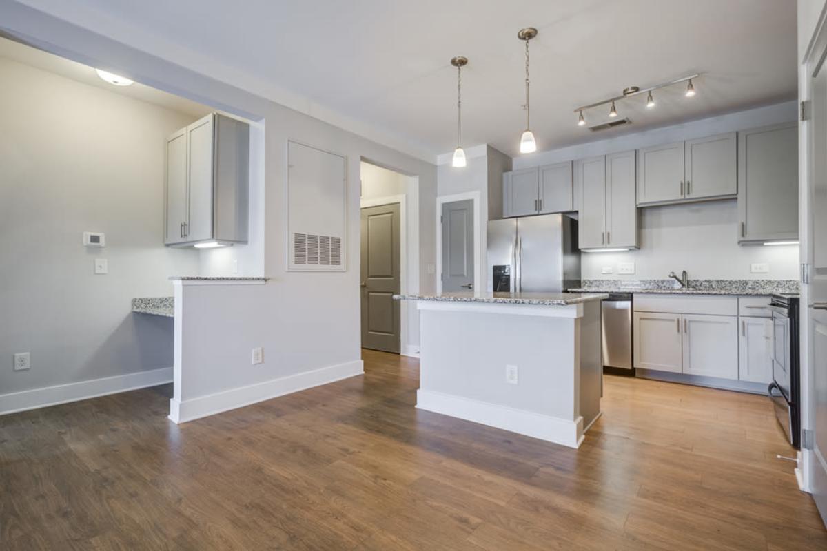 A photo of kitchen area with hanging cabinets and modern appliances at Century Park Place in Morrisville, North Carolina