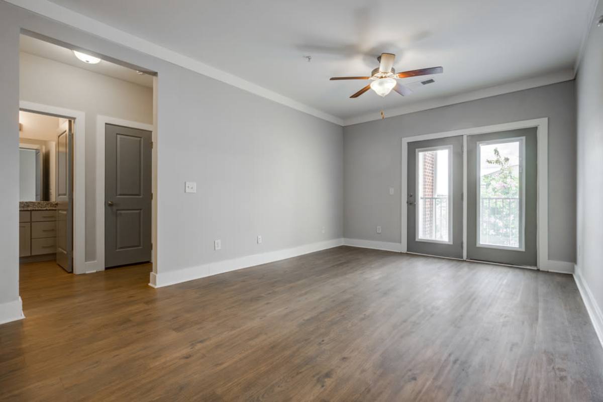 An empty living room with hallways going to a different room at Century Park Place in Morrisville, North Carolina