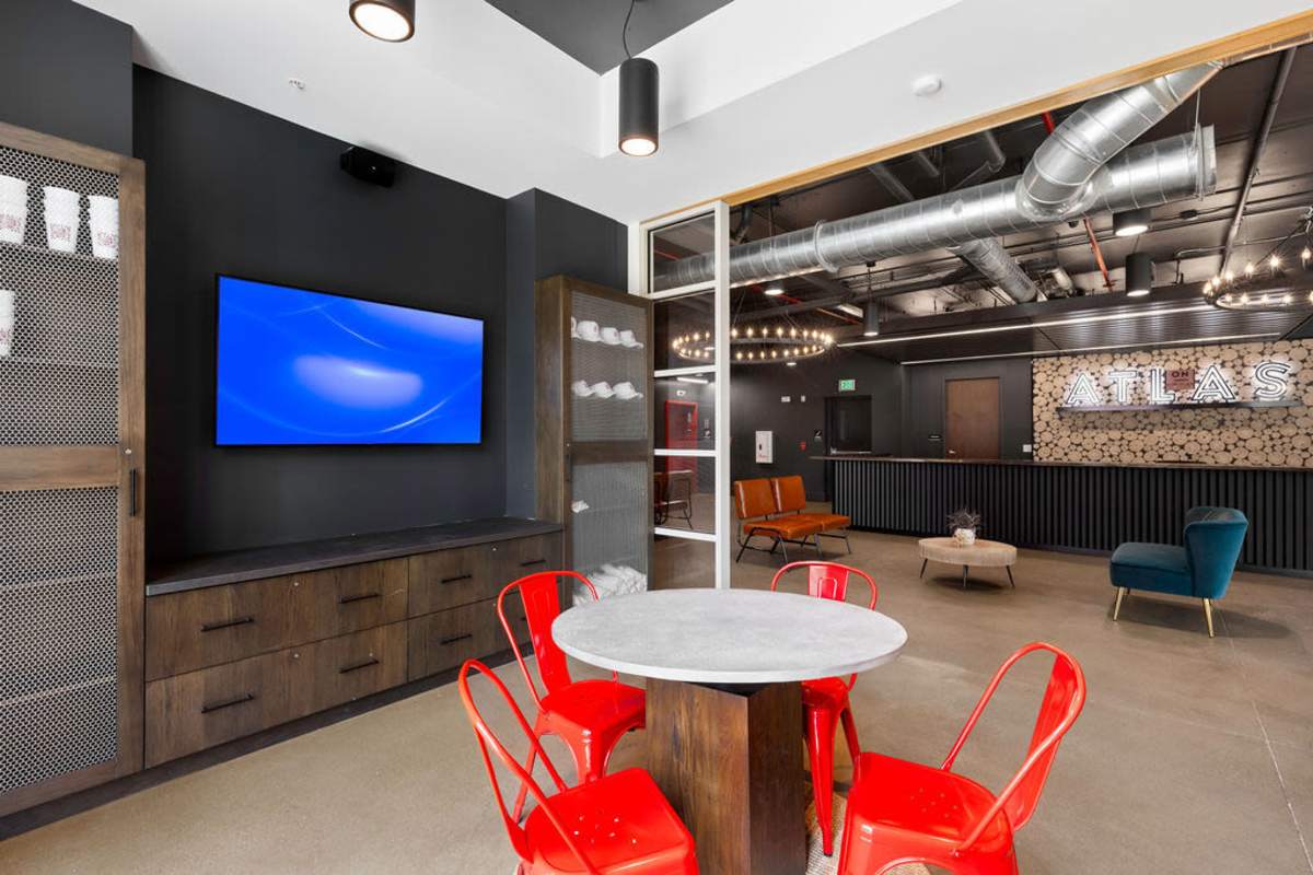 Clubhouse TV setup with seating arrangement at Atlas on 17th in Bloomington Indiana
