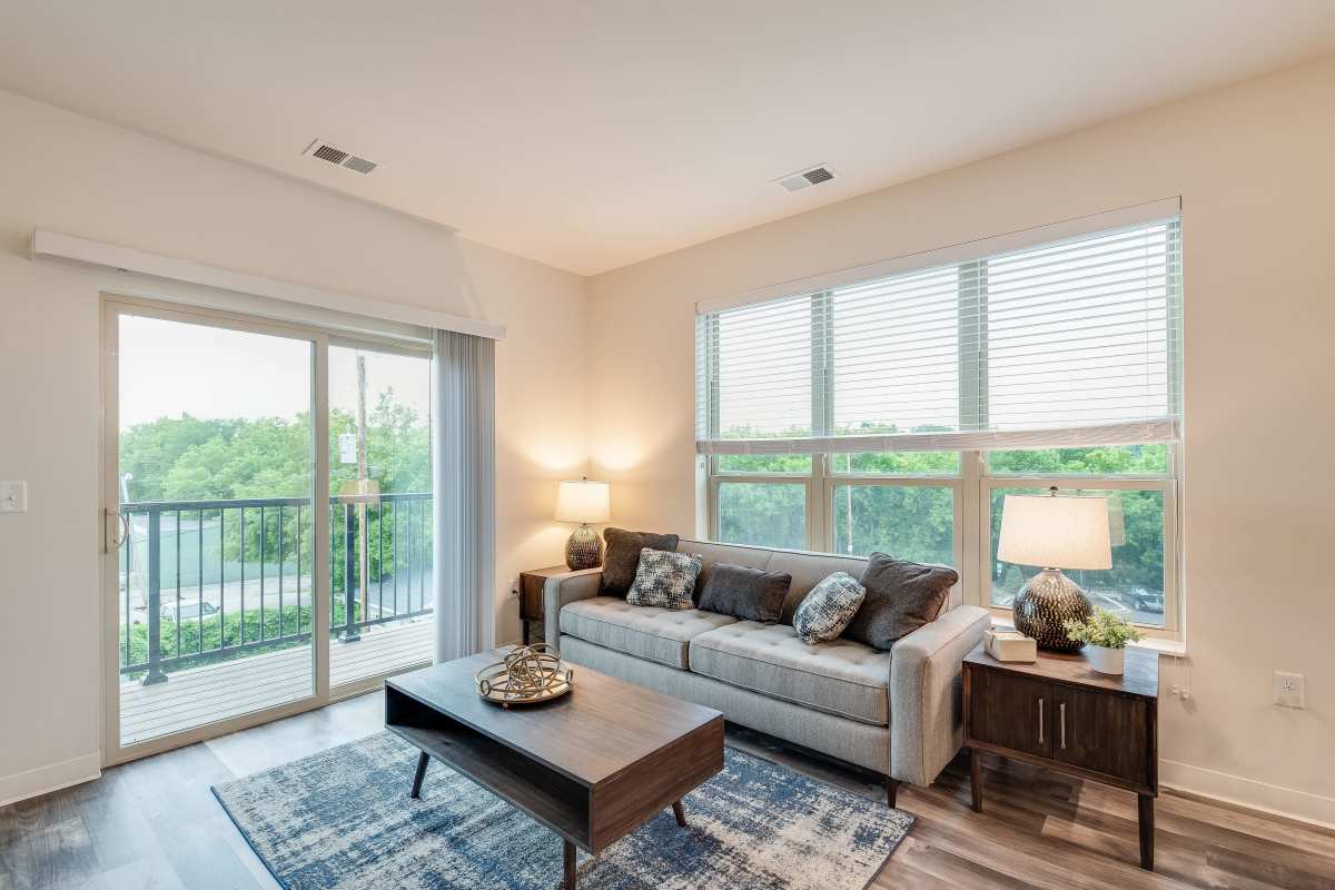 Living room with access to balcony at Spring City Crossing in Waukesha, Wisconsin